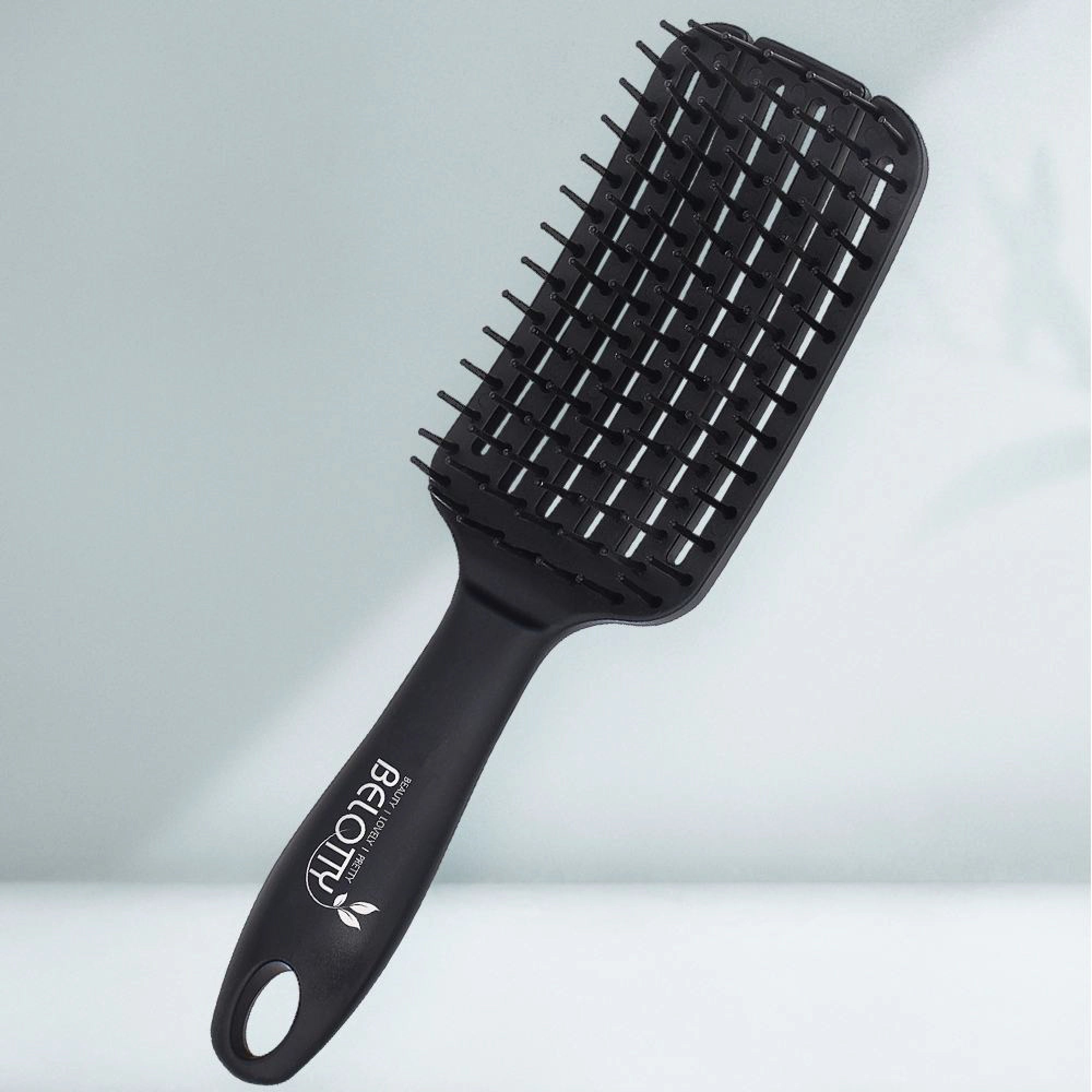 Black hairbrush with 'Belotty' branding on a light gray background