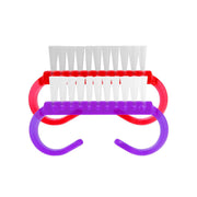 Nail brush with red and purple handle on a white background